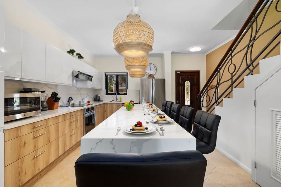 Dine in style at our kitchen island oasis. Pull up a chair and indulge in culinary delights while basking in the warm glow of good company and delicious food.