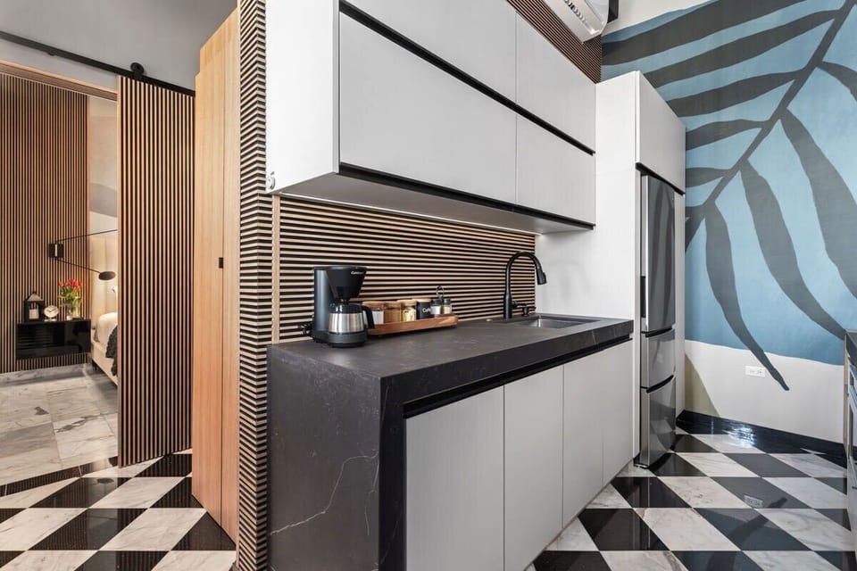 Love how the checkered floors combine with the modern wallpaper and the wood accents