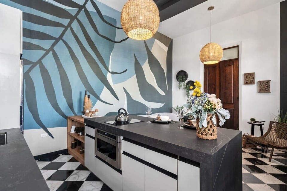 Villa Mosaico's kitchen has a beautiful island with black stone tops.