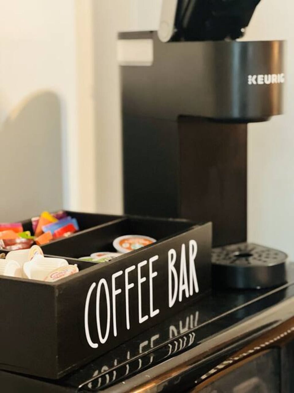 Keurig coffee maker, K-Cups, tea, creamer, and sugars provided.