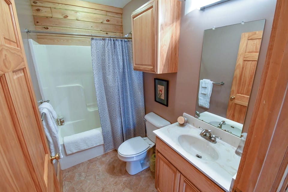 1 of 3 full size bathrooms with shower/tub combo