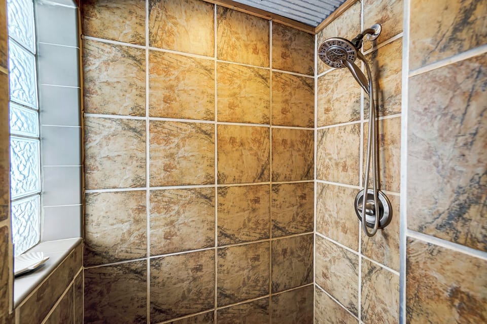 Shower with handheld adjustable shower head.