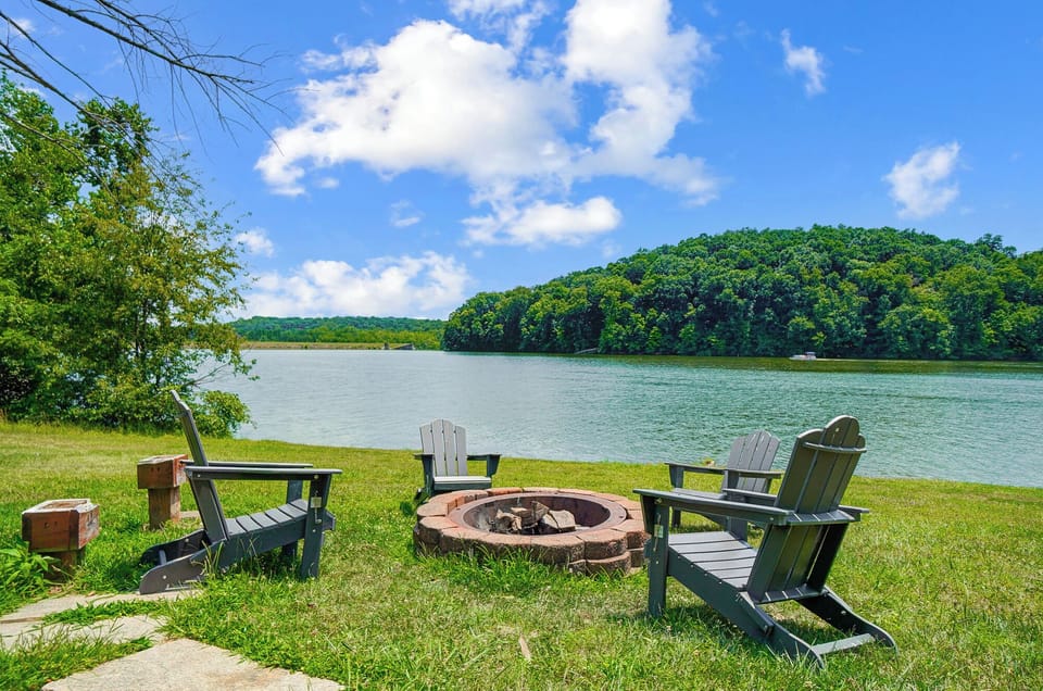 Enjoy sunsets by the lake with the outdoor fire pit featuring seating for 4.