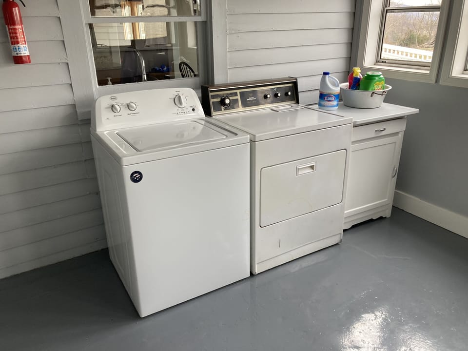 Washer and dryer on the back porch with plenty of detergent for your use.