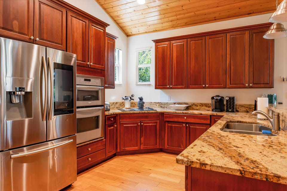 Our kitchen equipped with a modern fridge, oven, microwave and other appliances.