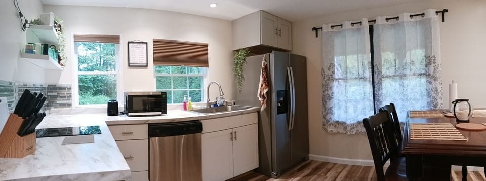 Kitchen. Stove top with 2 burners, toaster, microwave dishwasher, fridge.