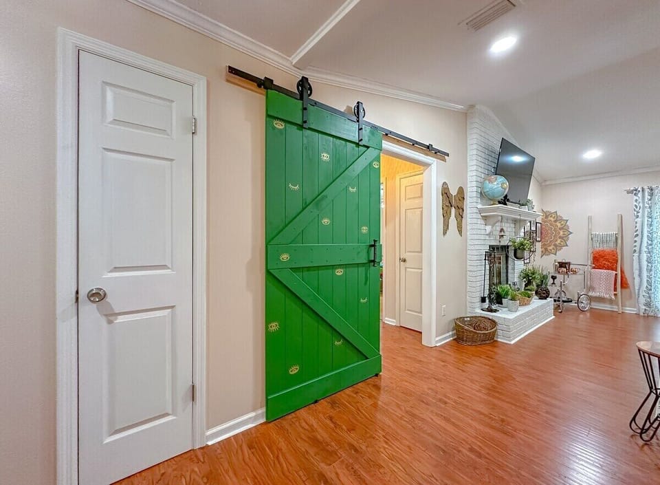 Barn door reduces noise between living room and sleeping quarters