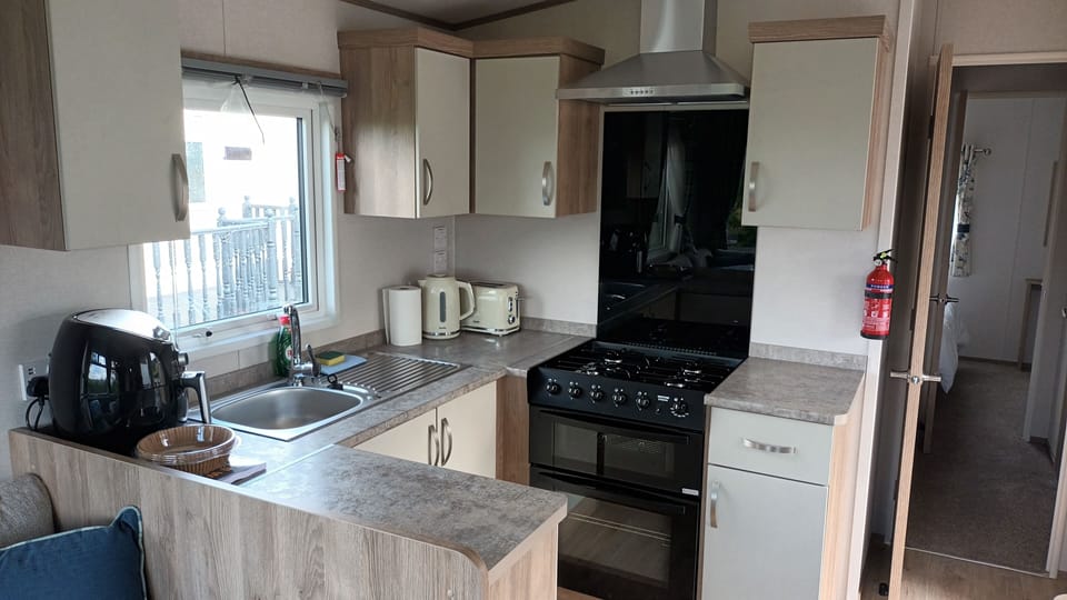 Mobile Home, 2 Bedrooms (Suki) | Private kitchen | Full-size fridge, microwave, oven, stovetop