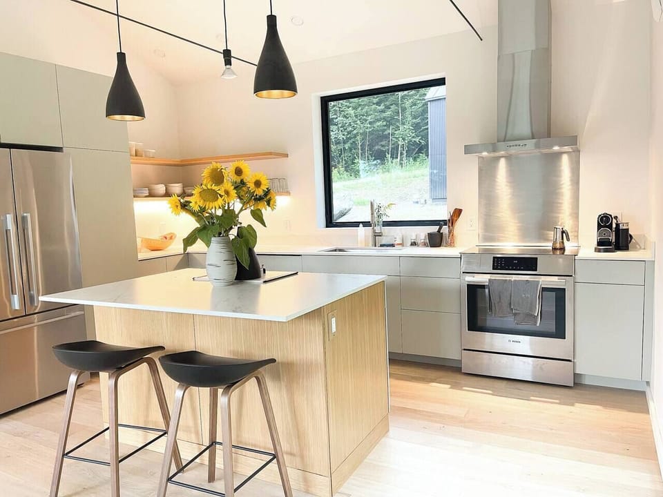 Modern chef's kitchen with island & luxury appliances.