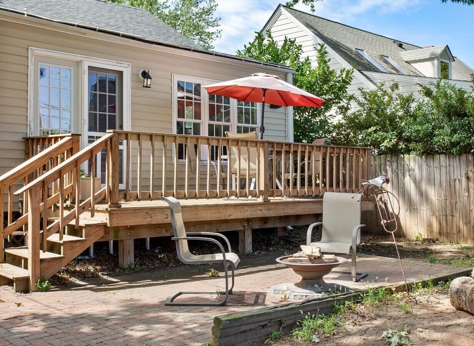 Relax outdoors on C‑spring motion chairs with umbrella and table. Surrounded by old‑growth trees, the fully fenced backyard offers shade, privacy, and a peaceful retreat. Cozy up next to the fire pit at night!