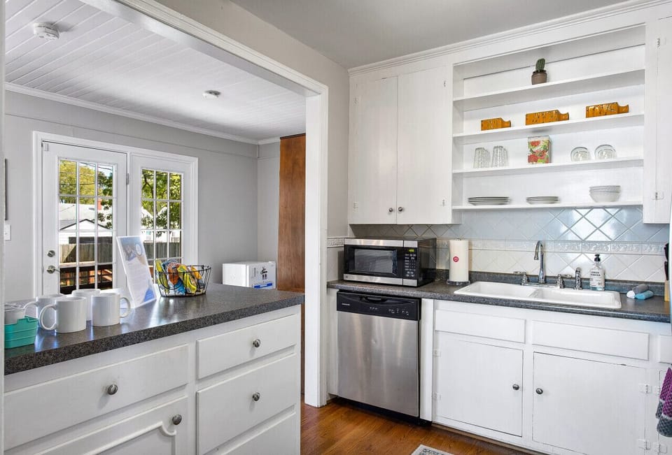 Open kitchen layout receives amazing morning natural light from a private back yard area. Fully stocked with cookware and serveware, oils & spices, Keurig coffee maker and more!