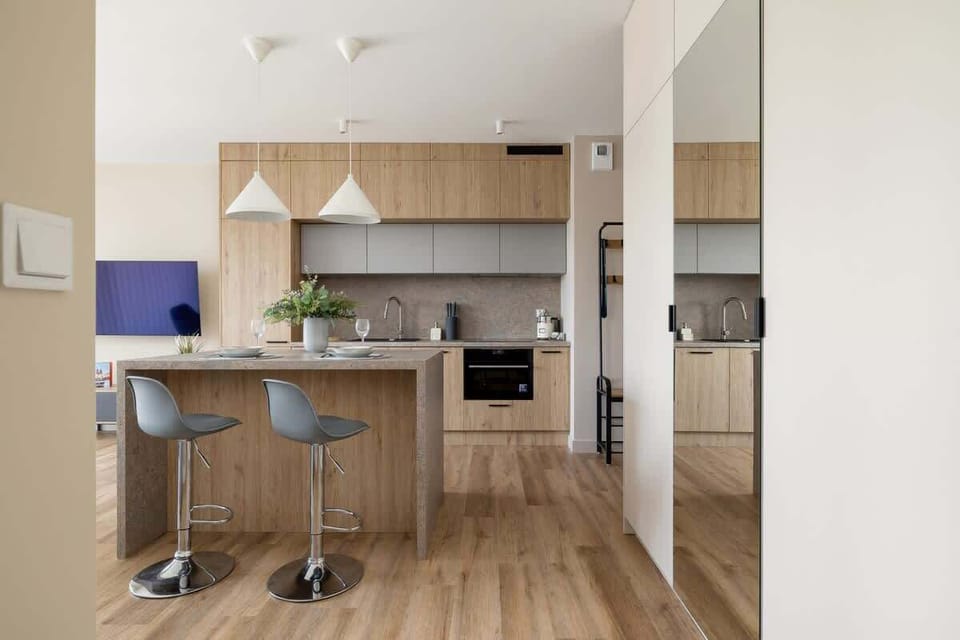 A modern kitchen island with bar stools, blending style and functionality in the open-plan layout.
