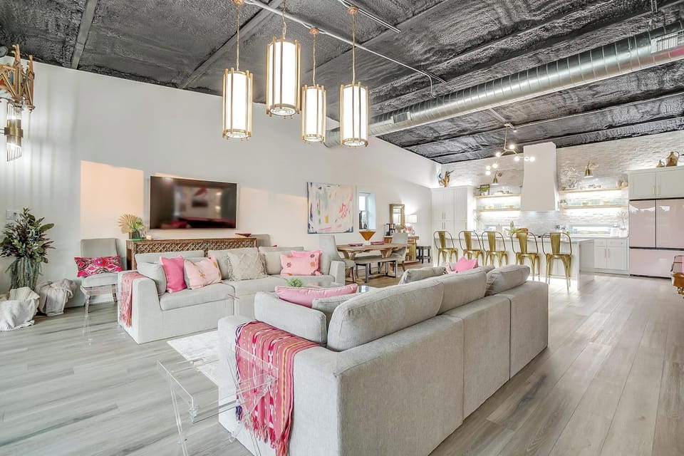 Open-concept living, dining, and kitchen all flowing together under soaring ceilings. The Noir sleeps 12 and feels nothing like a rental.