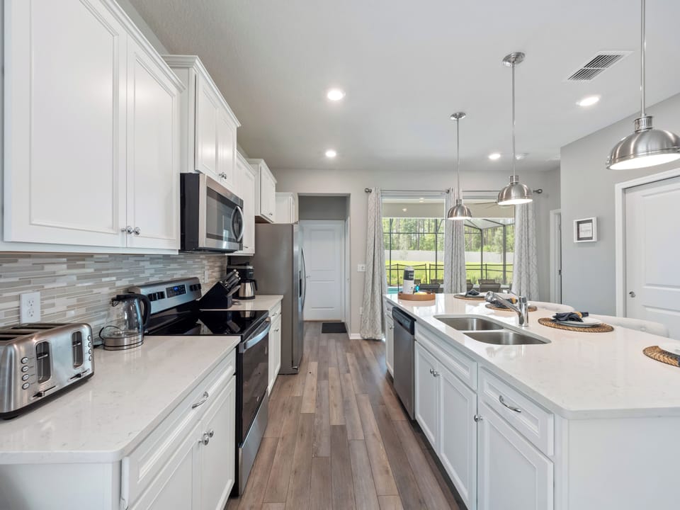 Spacious Full Size Kitchen Area with Kitchen Essentials and Barstool Seating