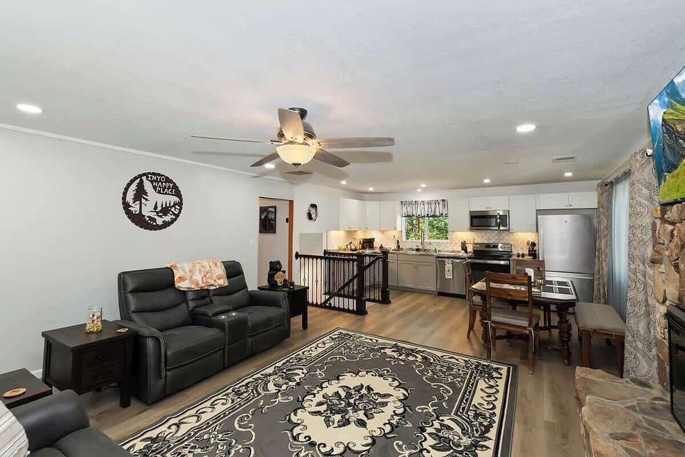 Living room with comfy sofa, ceiling fan, and plenty of room to move around