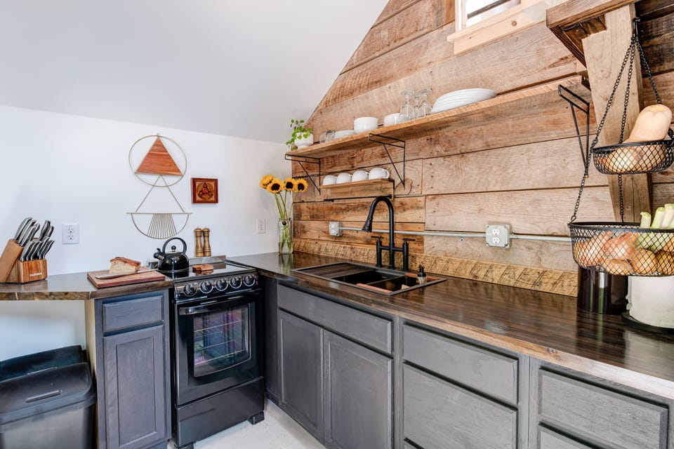 The beautifully designed kitchen with original barn wall and shelf.