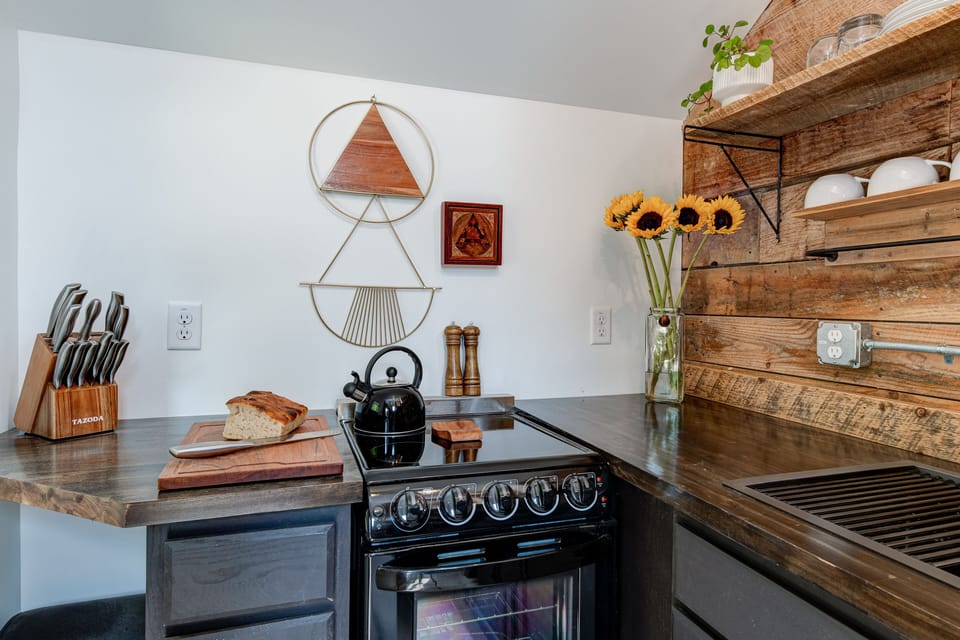 An oven with four burner stove available.