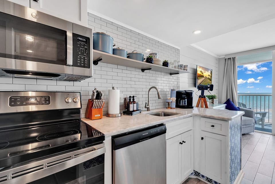 Ocean-Inspired Culinary Haven: Cornflower Blue Pots, Granite Countertops