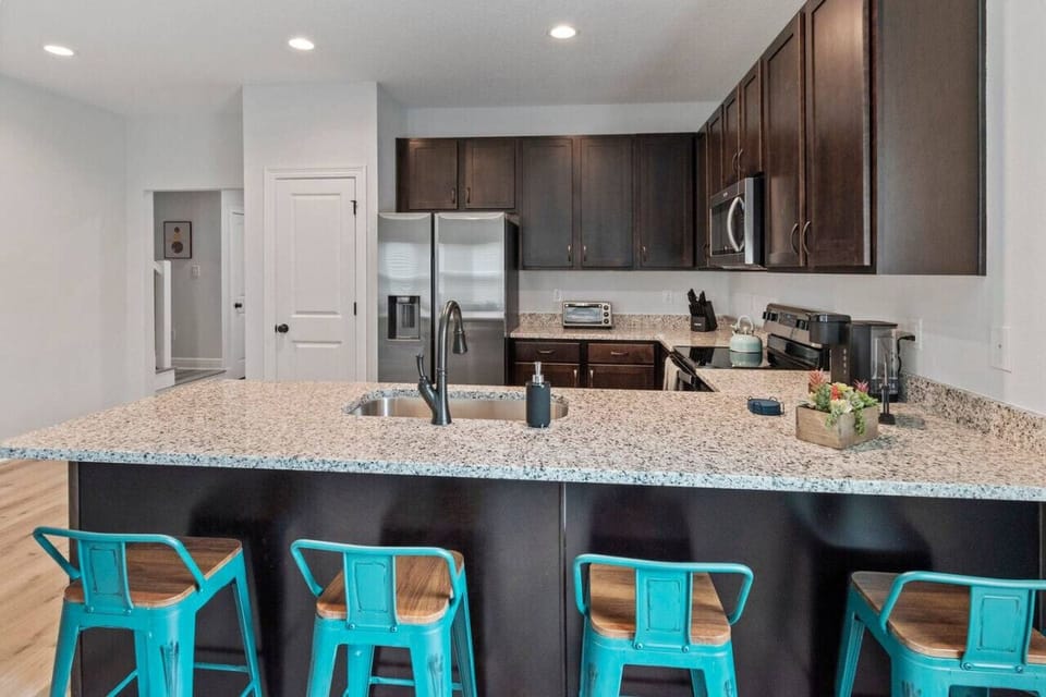 Fully equipped kitchen: Keurig, toaster oven, stainless steel appliances.