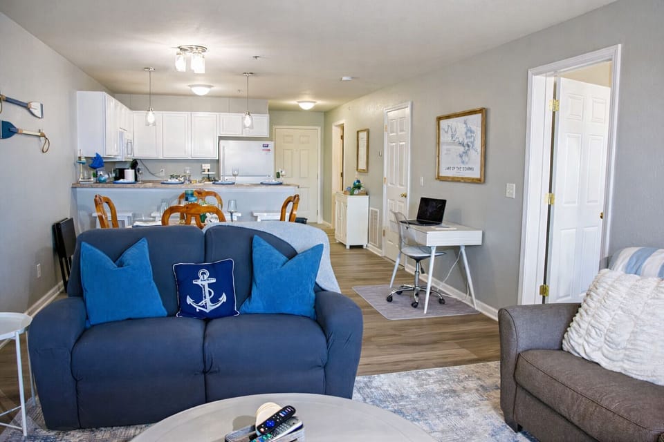 Bright living room with pull-out sofa bed and open lakefront layout