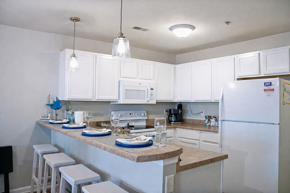 Fully stocked kitchen with bar seating and modern appliances