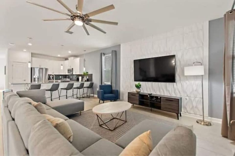 Living Room with Big Screen TV & Kitchen in Background