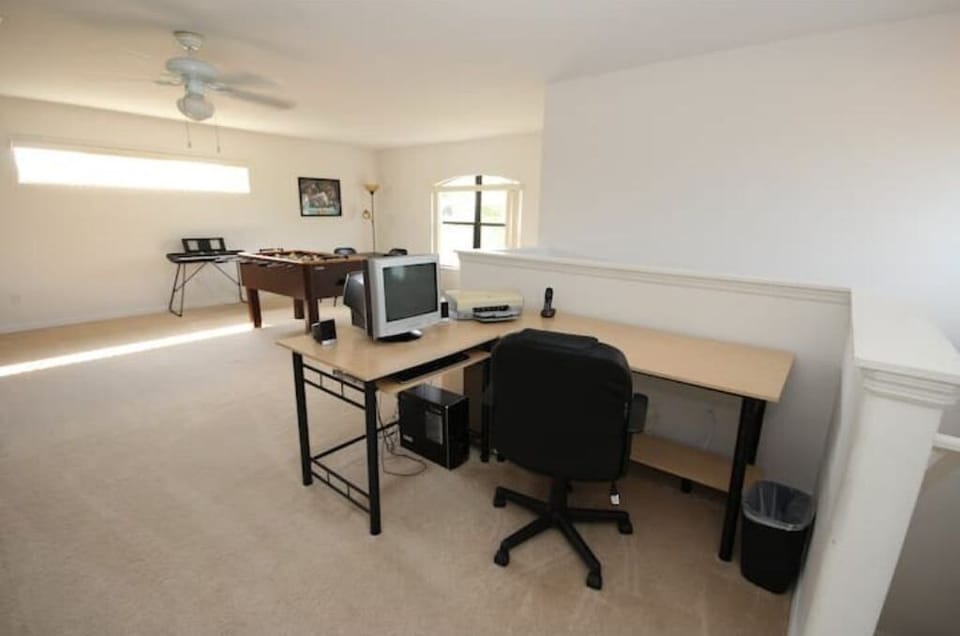 Computer for Work Area with Foosball Table in Background