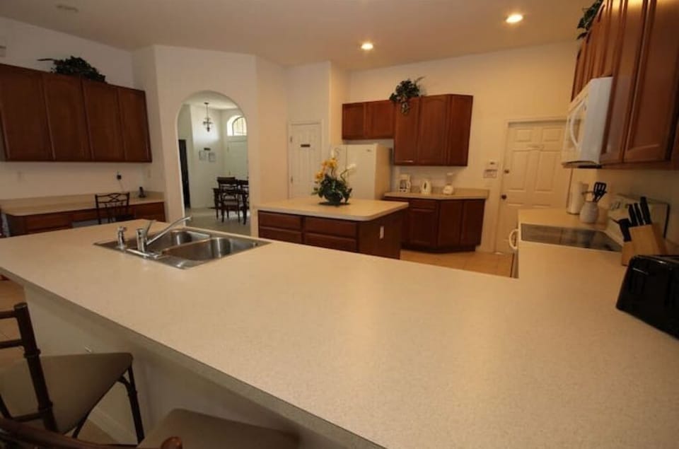 Kitchen View with Dual Sinks, Fridge, Microwave & Stove