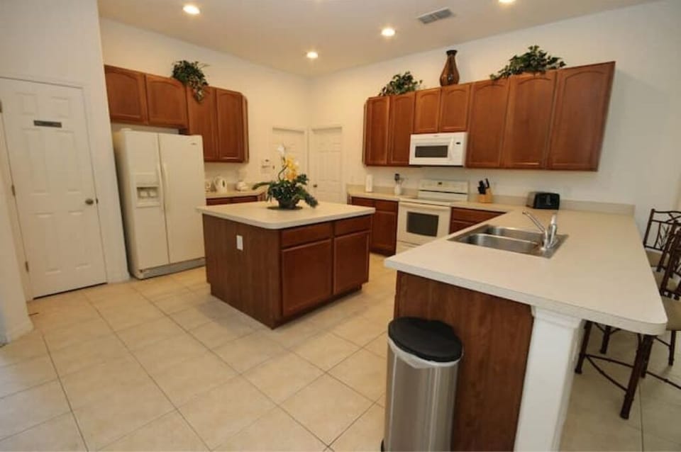 Kitchen View with Fridge, Stove, Microwave, & Dual Sinks