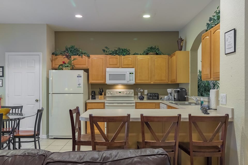 Kitchen Island that Seats 4 People with Kitchen in Background