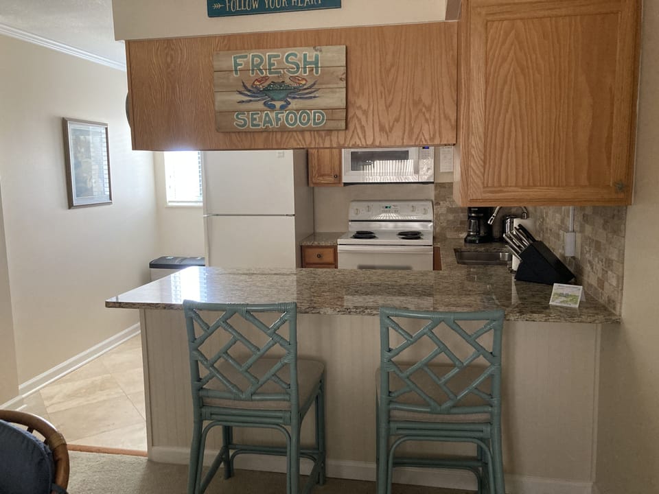 Kitchen counter has two stools