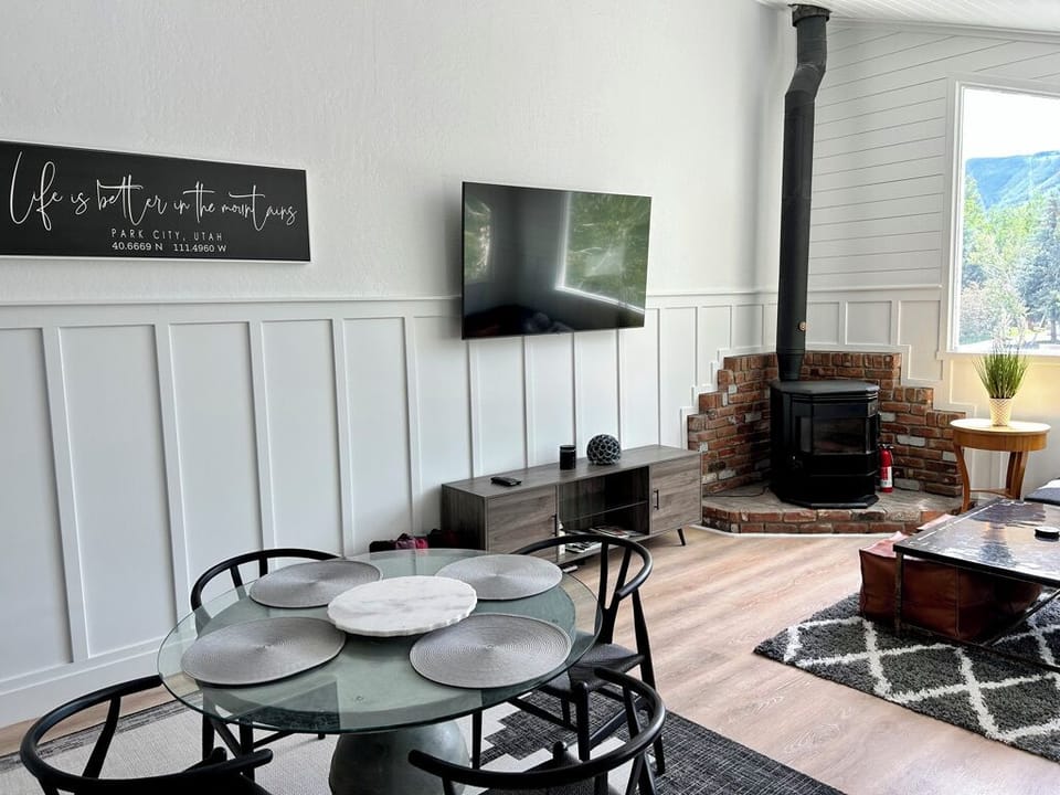 Family room with TV, fireplace and windows overlooking Park City ski run