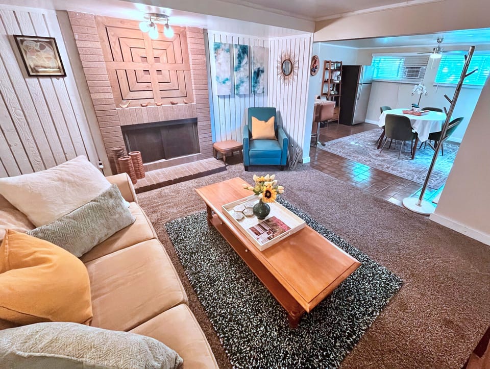 Cozy living room with fireplace and open dining area