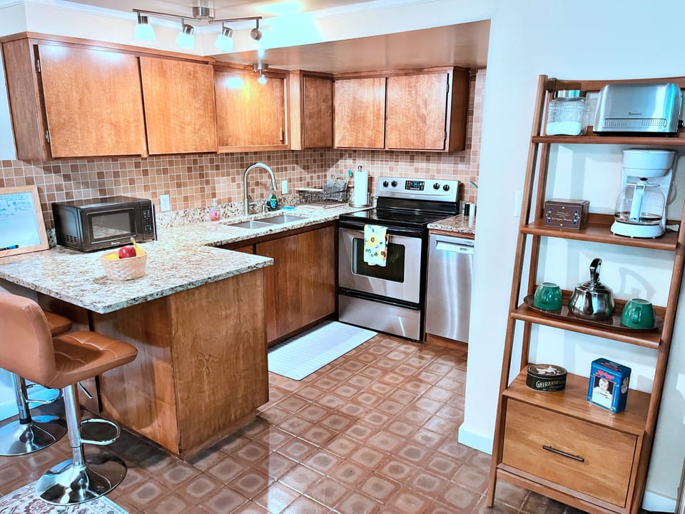 Cozy upgraded kitchen with granite counters, bar seating, and coffee station