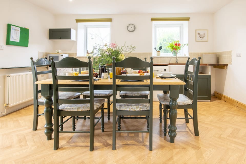 Ground floor: Dining table and chairs comfortably seating six guests