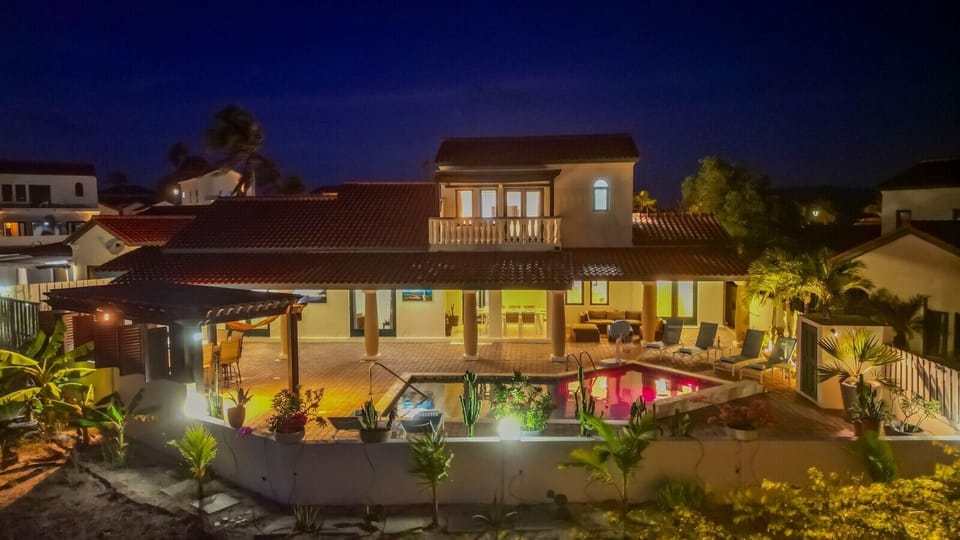 At night, the villa glows softly, offering a peaceful, relaxing, and beautifully lit atmosphere.