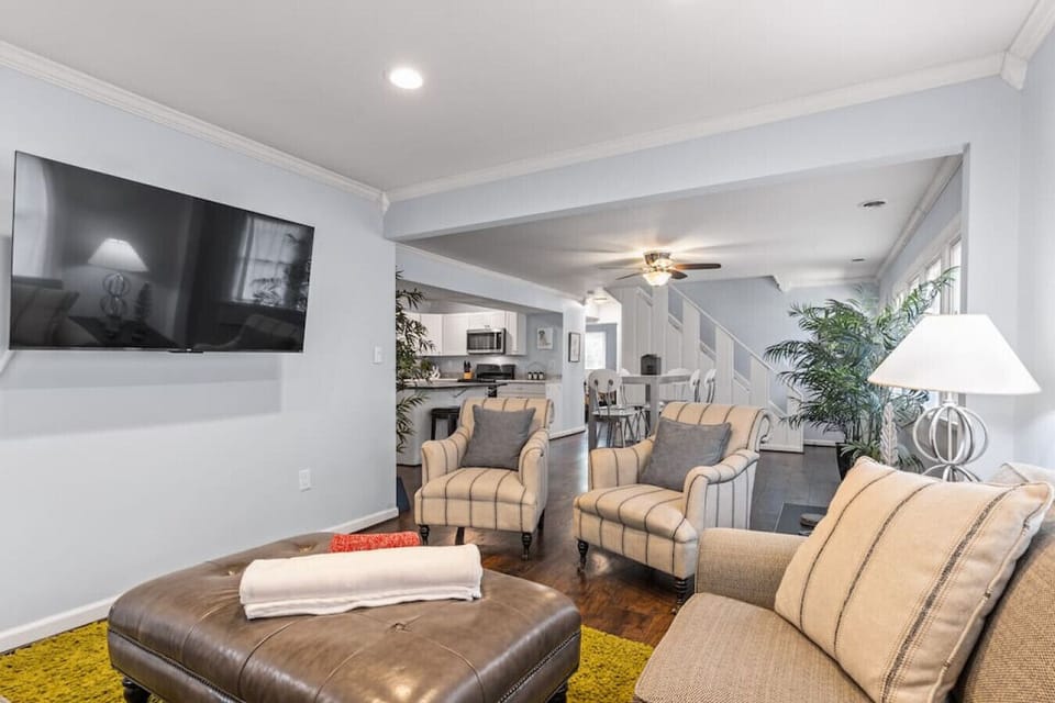 Comfy, spacious living room with flat screen Roku TV adjacent to the kitchen and dining area.