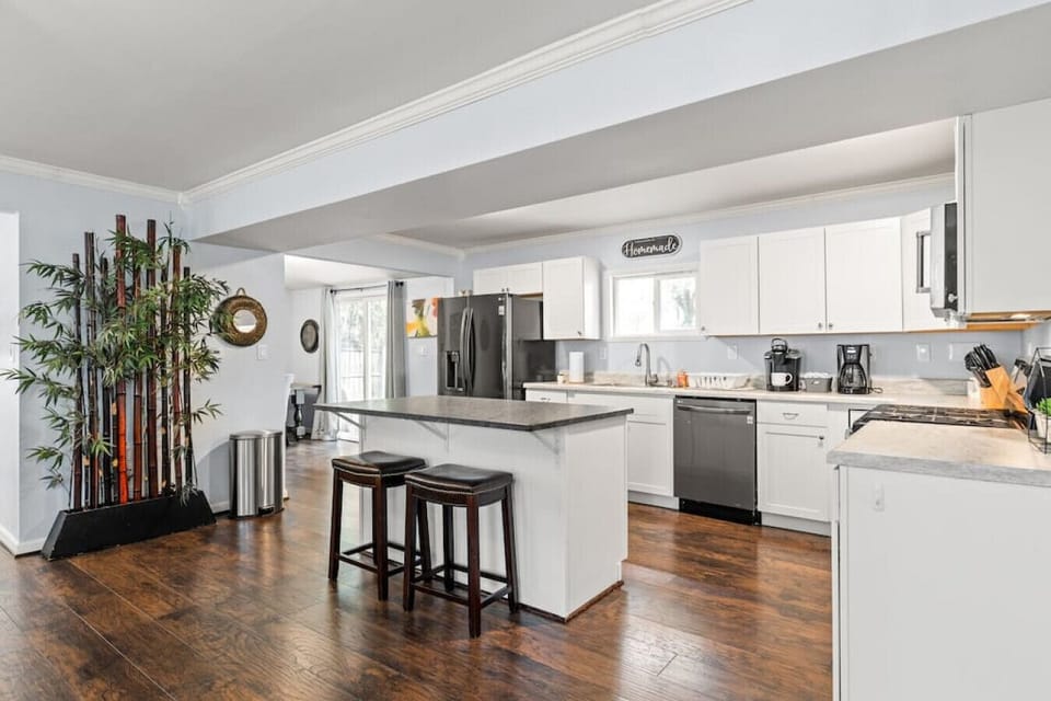 Well-appointed and modern kitchen with island, fridge, freezer, dishwasher, Keurig, drip coffee maker, stove, ample storage space and more!