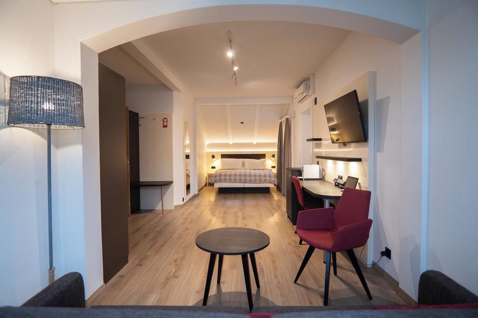Family Suite (Air Conditioning) | Living area | 32-inch flat-screen TV with cable channels, TV