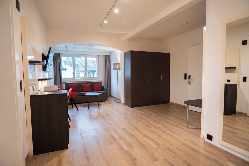 Family Suite (Air Conditioning) | Living area | 32-inch flat-screen TV with cable channels, TV