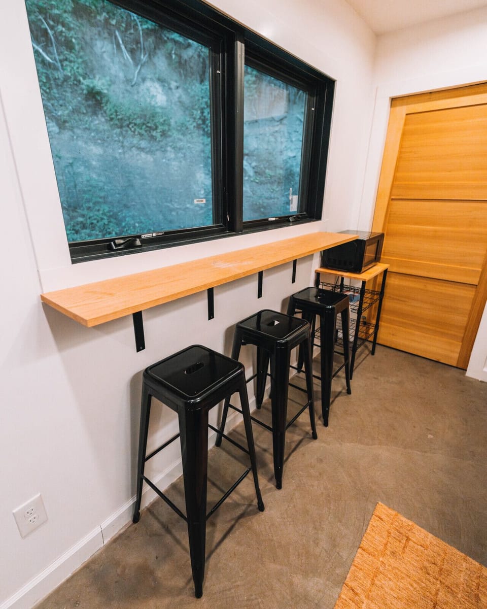 Enjoy breakfast at the slim bar counter while the rocky hillside view adds quiet mountain escape character