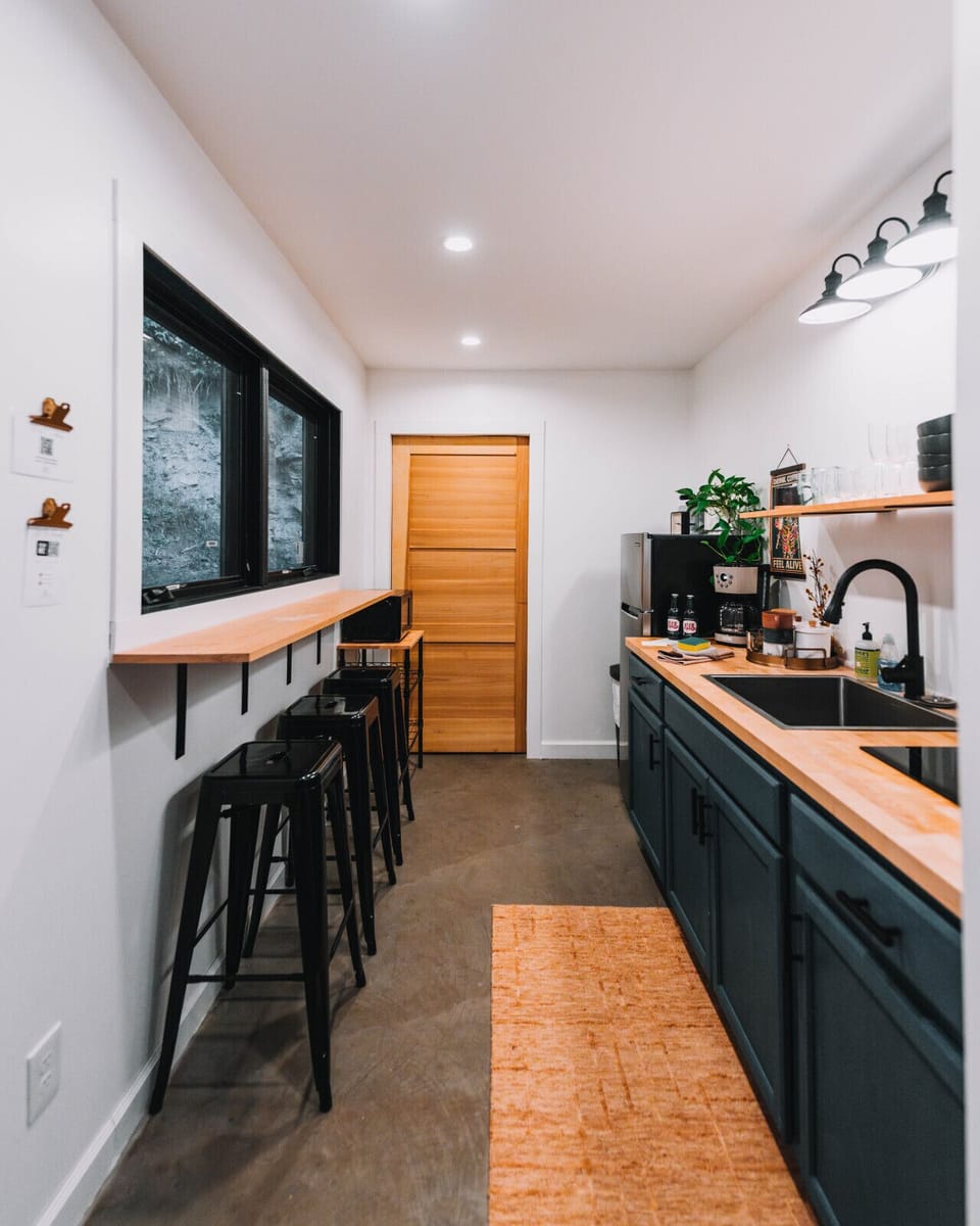 Prepare simple cabin meals together in the bright kitchen, then enjoy them at the window-side bar seating