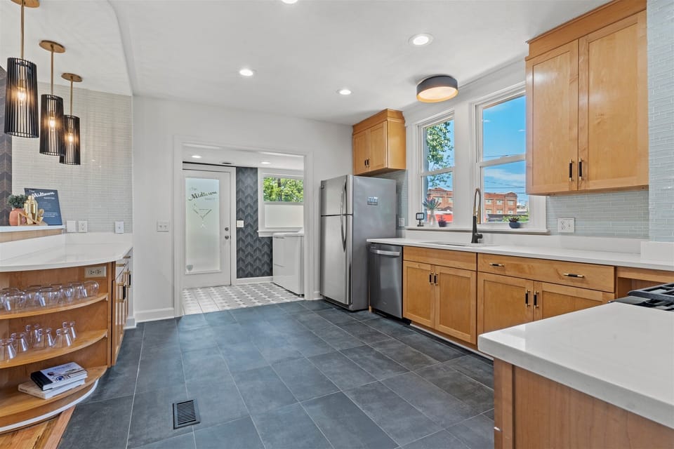 Sleek wood cabinetry, modern finishes, and plenty of storage make this kitchen as functional as it is stylish.