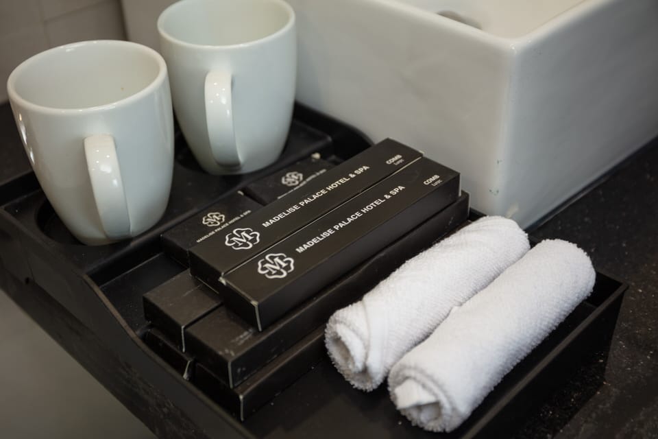 Designer toiletries, hair dryer, slippers, towels