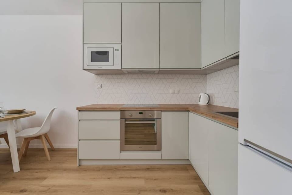 A compact kitchen with light-colored cabinets, modern appliances, and a practical layout.
