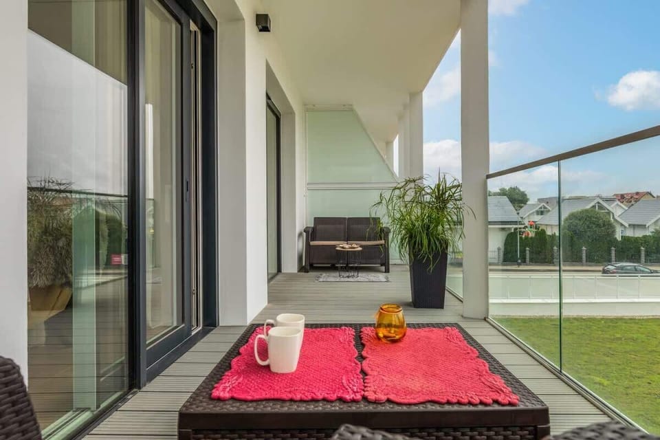 Another balcony setup featuring a comfortable seating area with cushions and a small table for relaxation.
