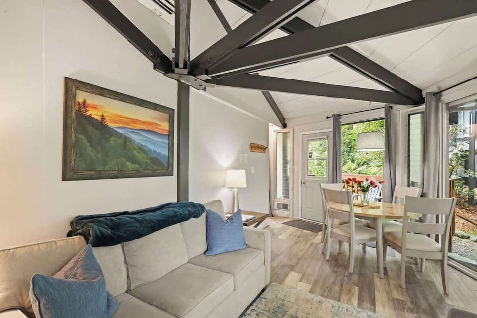 Our living room is the heart of winter charm – a place where mountain views and fireside coziness converge. Embrace après-ski relaxation in style!