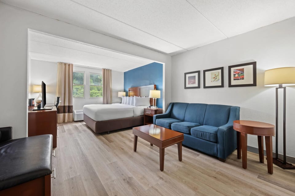 Premium bedding, desk, laptop workspace, blackout drapes
