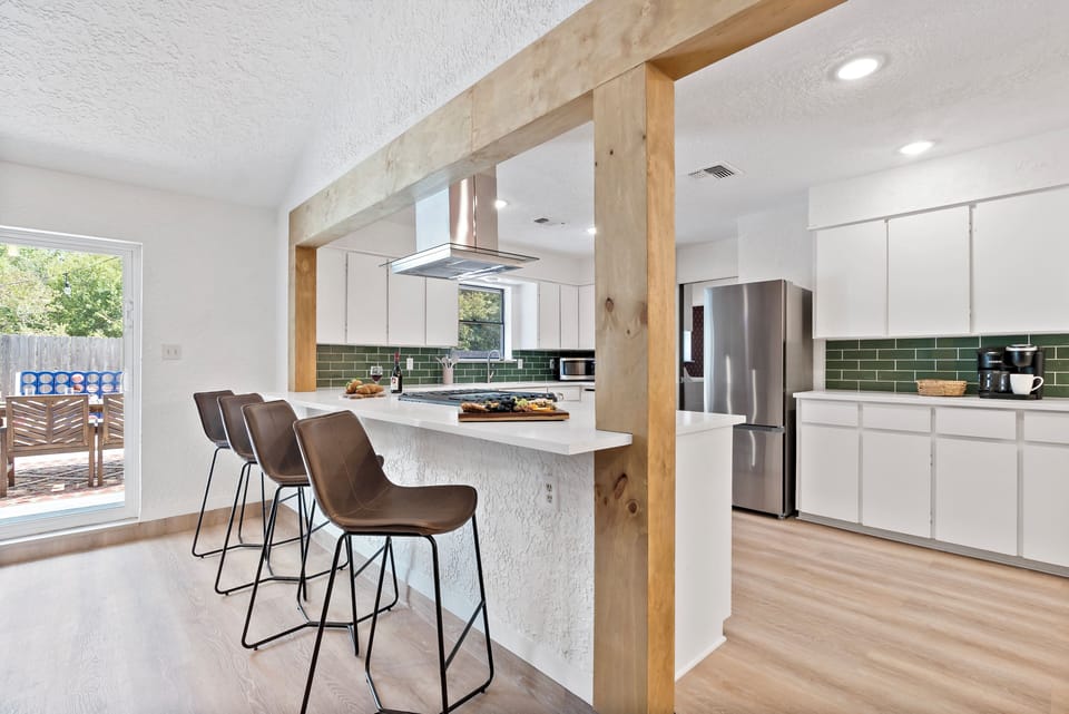 Kitchen: bright and festive with modern touches and a seamless flow to the patio