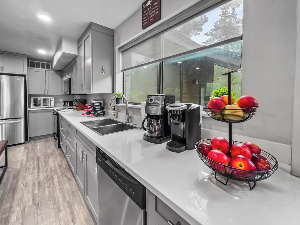 This fully equipped gourmet kitchen offers a clean, contemporary design with ample workspace. Whether preparing a quick snack or a full feast, enjoy top-tier functionality and style.